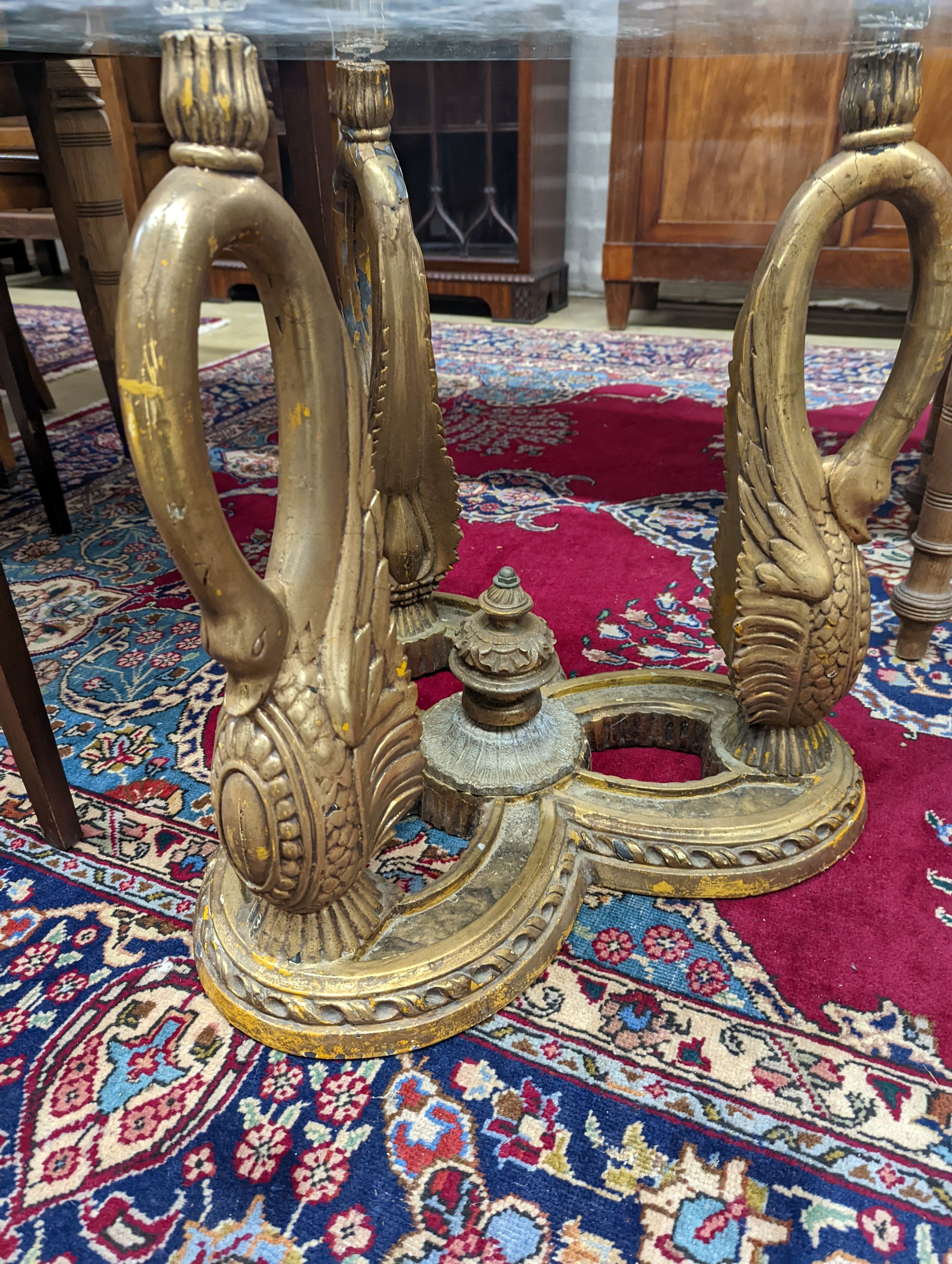 A pair of Empire style circular glass top gilt metal ‘swan’ occasional tables. D-69cm, H-55cm.